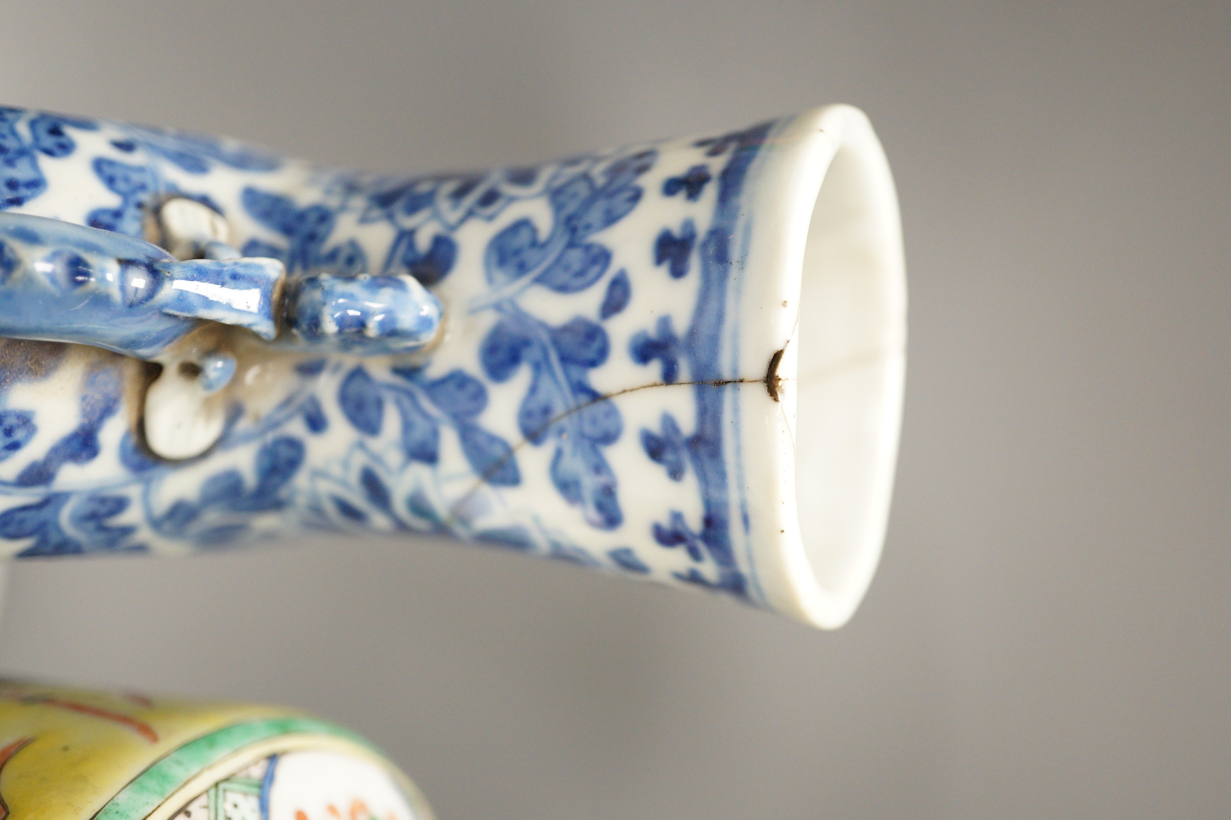 A Chinese famille verte vase and cover, a yellow ground ‘soldiers’ vase, a blue and white moonflask and a similar’dragon’ sleeve vase, all late 19th/early 20th century, Tallest 33cm